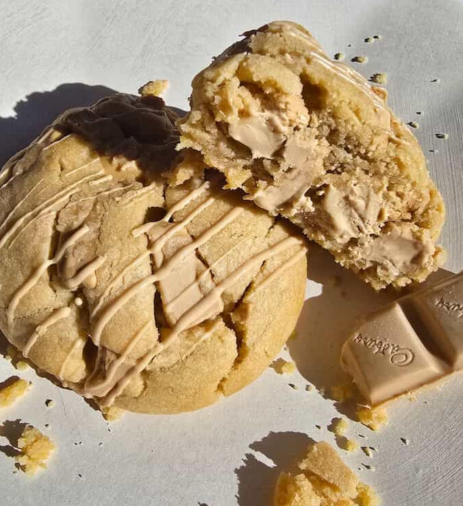 Giant gooey white caramel loaded cookie with oozing Cadbury Caramilk center- Crumbology handmade fresh in Mandurah & Peel region WA